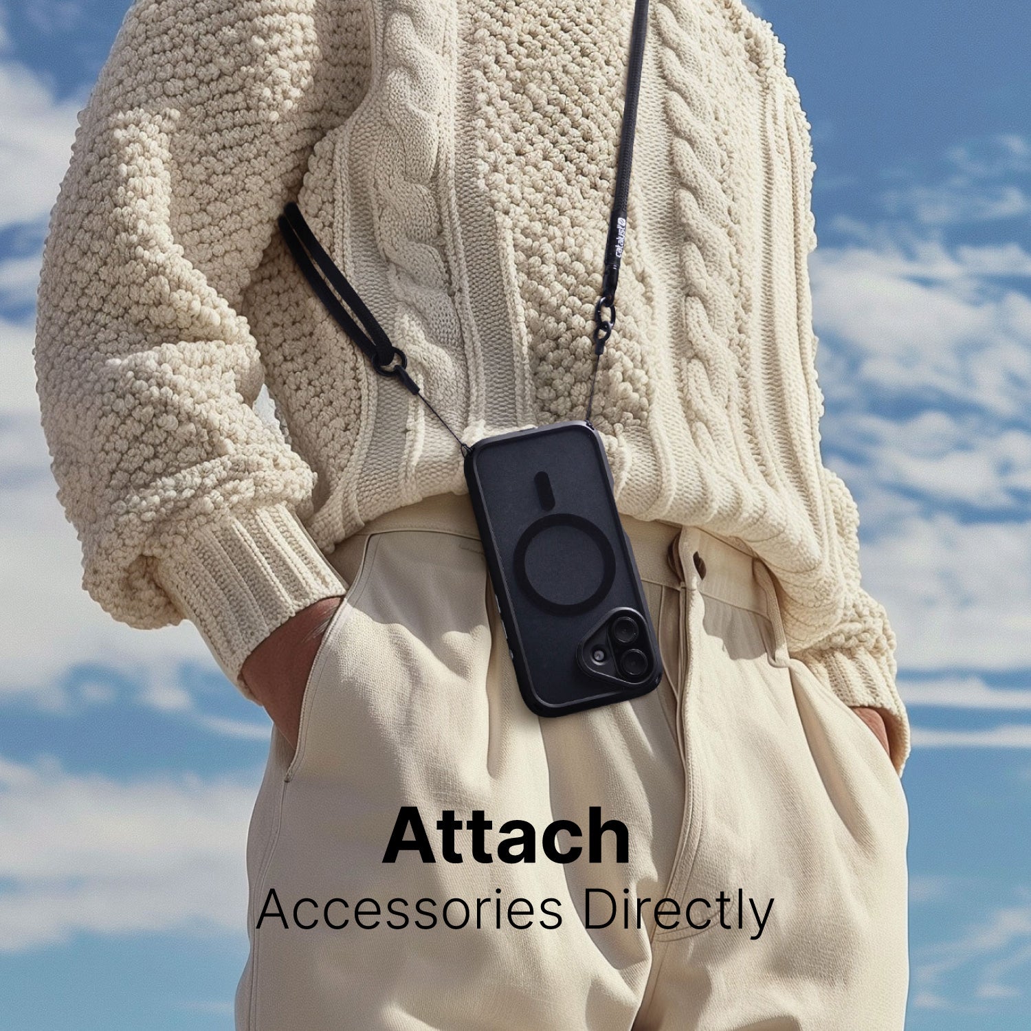 Person wearing a cream knit sweater and beige pants with a Catalyst Drop Proof Case in black hanging from a strap around their neck. The words "Attach Accessories Directly" are displayed at the bottom.