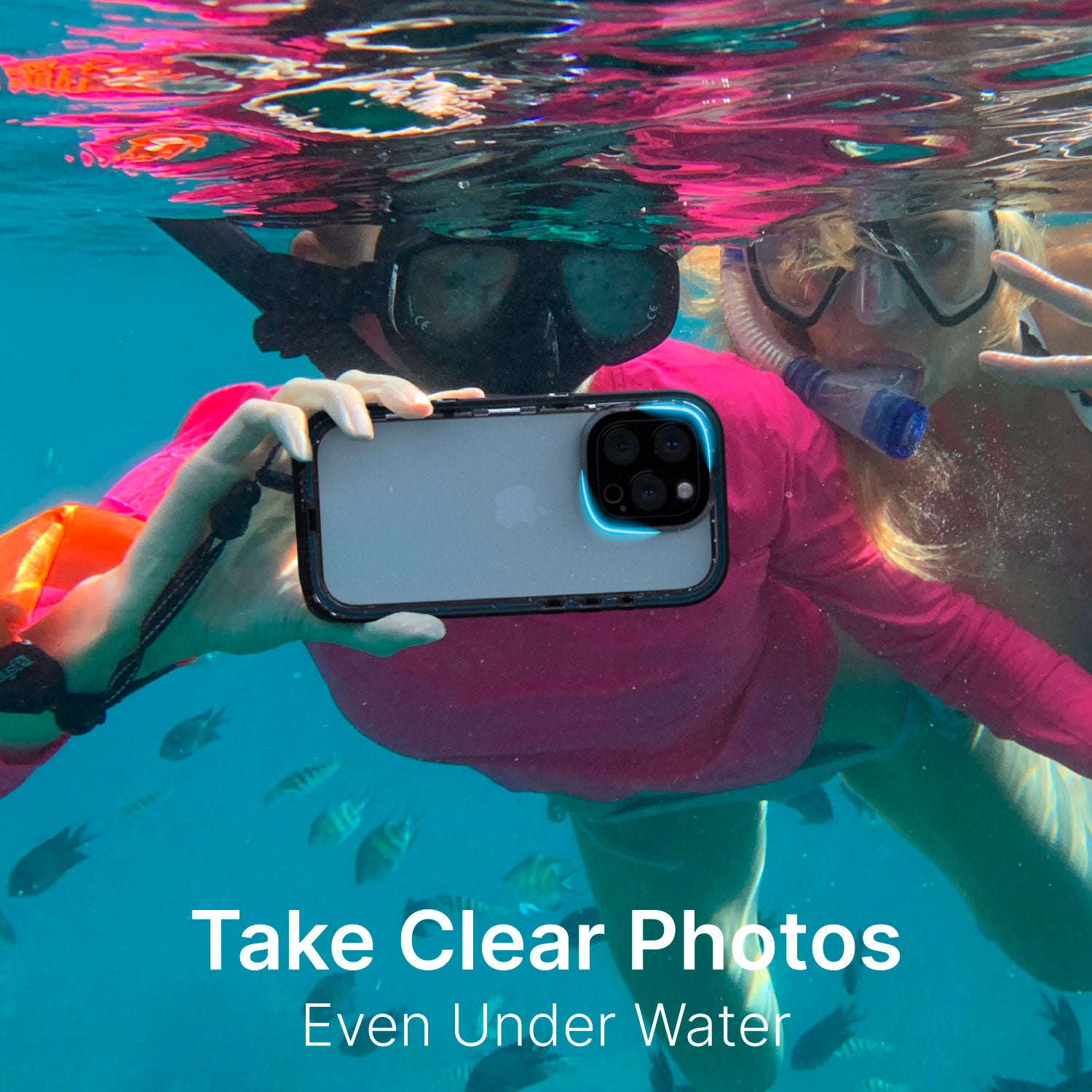 Two people underwater use the Catalyst iPhone 16 Pro - Waterproof Case, Total Protection in black, wearing masks and snorkels. Text reads: "Take Clear Photos Even Under Water." Fish swim behind them.